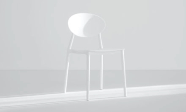 a white chair kept in front of sunlight in a room